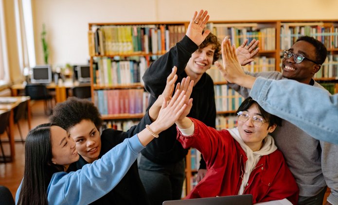 Zdjęcie grupy studenckiej - przebijają "piątkę"